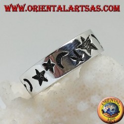 Smooth silver ring with thick engravings of stars and moons