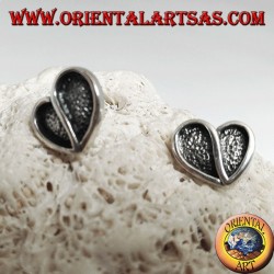 Heart-shaped silver earrings hollowed out in bas-relief from a lobe