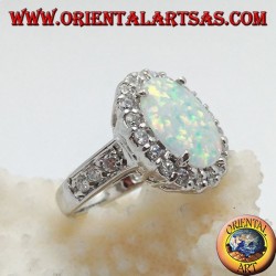 Silver ring with oval harlequin opal set with zircons around and on the sides