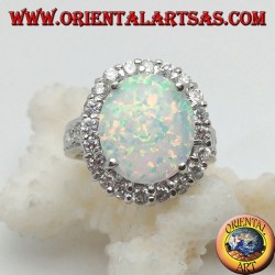 Silver ring with oval harlequin opal set with zircons around and on the sides