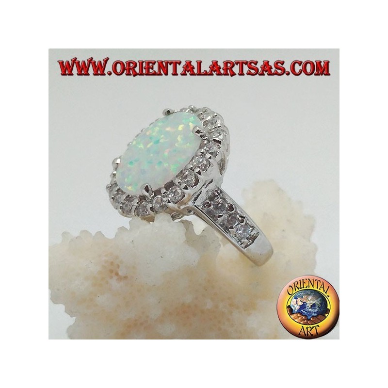 Silver ring with oval harlequin opal set with zircons around and on the sides