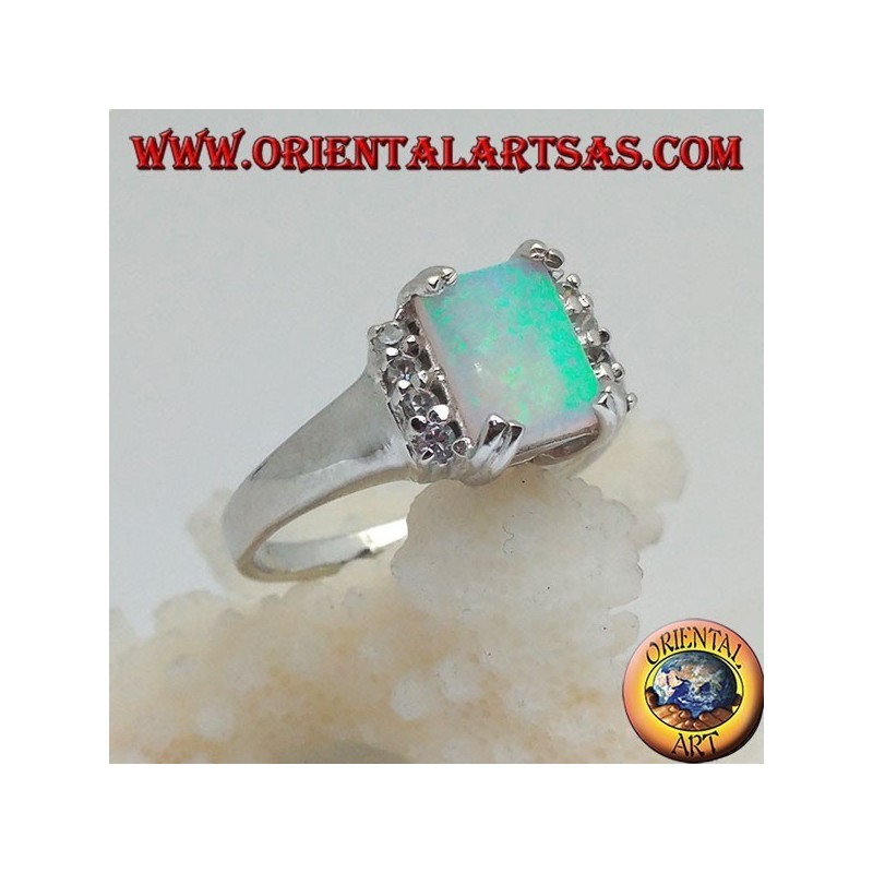 Silver ring with rectangular harlequin opal set in four and row of zircons on the sides