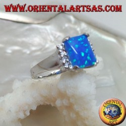 Silver ring with rectangular blue opal set in four and row of zircons on the sides