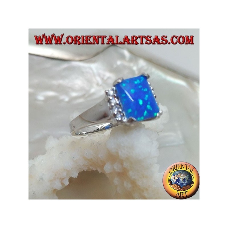 Silver ring with rectangular blue opal set in four and row of zircons on the sides