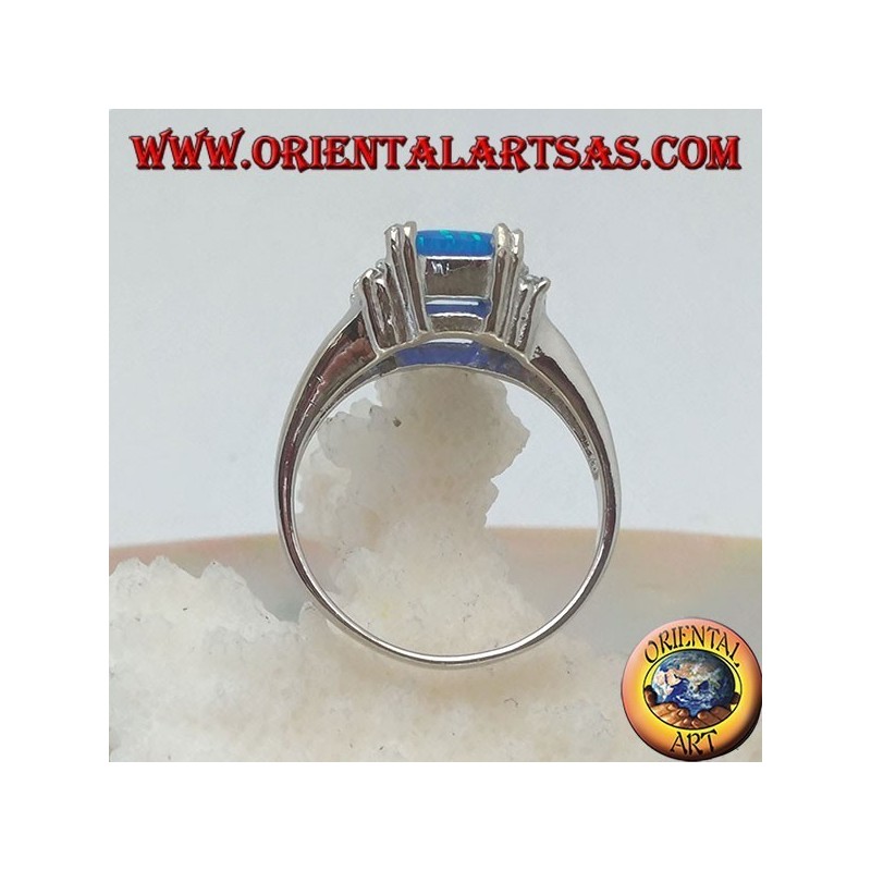 Silver ring with rectangular blue opal set in four and row of zircons on the sides