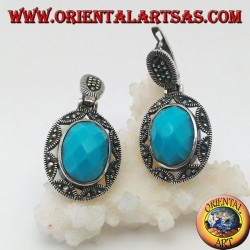 Silver earrings with oval turquoise faceted cabochon surrounded by a star and marcasite fretwork