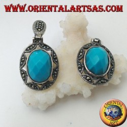 Pendientes de plata con cabujón de turquesa ovalado facetado rodeado de una estrella y calado de marcasita