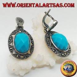 Pendientes de plata con cabujón de turquesa ovalado facetado rodeado de una estrella y calado de marcasita