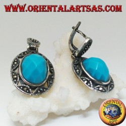 Silver earrings with oval turquoise faceted cabochon surrounded by a star and marcasite fretwork