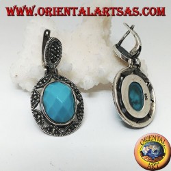Silver earrings with oval turquoise faceted cabochon surrounded by a star and marcasite fretwork