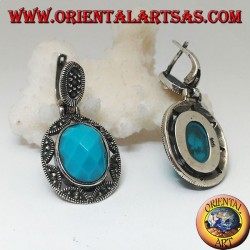 Pendientes de plata con cabujón de turquesa ovalado facetado rodeado de una estrella y calado de marcasita