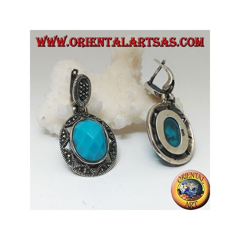 Pendientes de plata con cabujón de turquesa ovalado facetado rodeado de una estrella y calado de marcasita