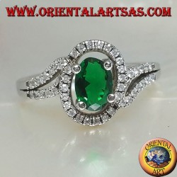 Anillo de plata con esmeralda sintética ovalada, rodeado de circonitas en una configuración concéntrica