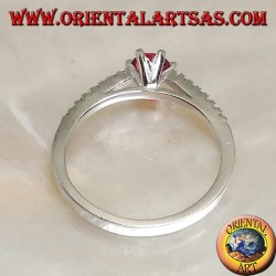 Silver ring with round synthetic ruby set on a thin row of cubic zirconia setting