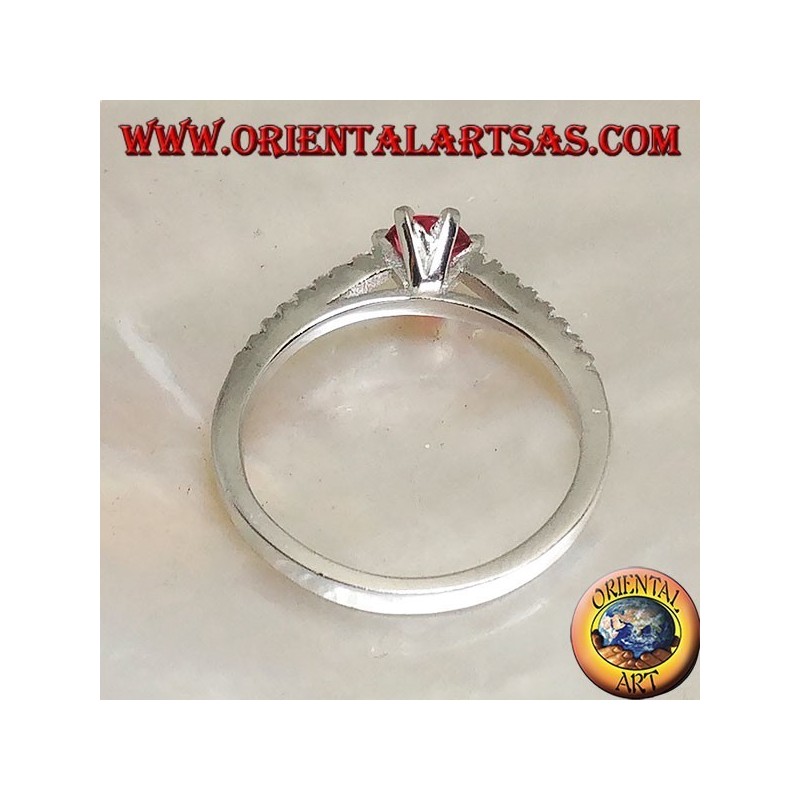 Silver ring with round synthetic ruby set on a thin row of cubic zirconia setting