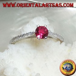 Silver ring with round synthetic ruby set on a thin row of cubic zirconia setting