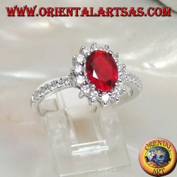 Silver ring with oval synthetic ruby set surrounded by cubic zirconia and row on the sides