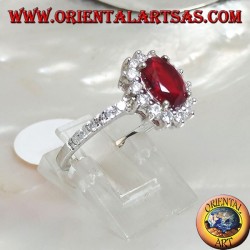 Silver ring with oval synthetic ruby set surrounded by cubic zirconia and row on the sides