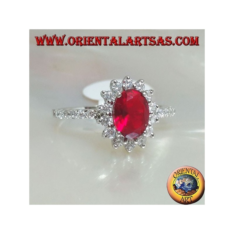Anillo de plata con rubí sintético ovalado engastado con circonitas cúbicas y fila a los lados.