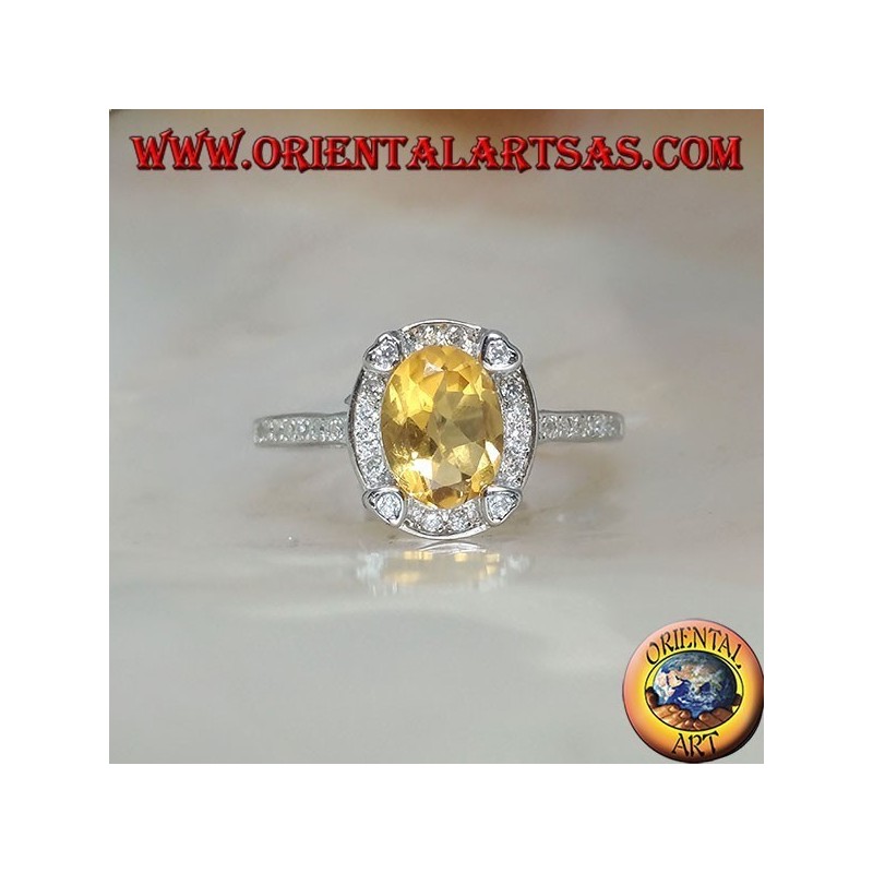 Silver ring with oval natural yellow topaz surrounded by cubic zirconia and with four cubic zirconia in relief