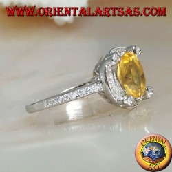 Silver ring with oval natural yellow topaz surrounded by cubic zirconia and with four cubic zirconia in relief