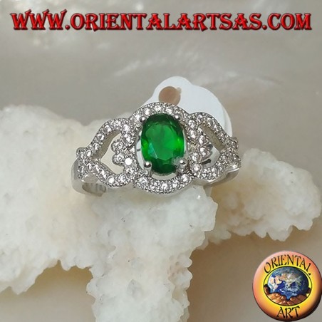 Silver ring with oval synthetic emerald on frame with hearts on the sides studded with zircons