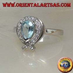 Silver ring with natural blue drop topaz surrounded by zircons (intersection on tip)