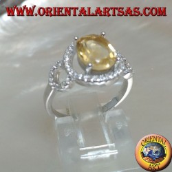 Silver ring with oval natural yellow topaz set on a three circle of zirconia setting