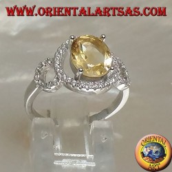 Silver ring with oval natural yellow topaz set on a three circle of zirconia setting
