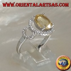 Silver ring with oval natural yellow topaz set on a three circle of zirconia setting