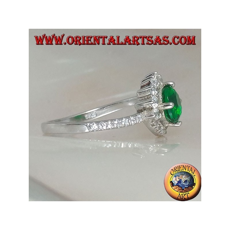 Silver ring with round synthetic emerald set surrounded by small and large zircons