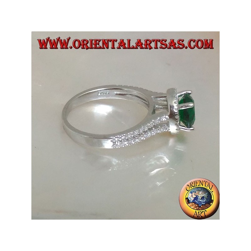 Silver ring with round synthetic emerald set surrounded by raised zircons