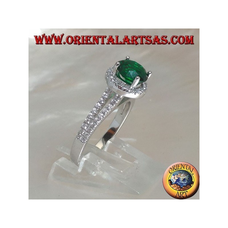 Silver ring with round synthetic emerald set surrounded by raised zircons