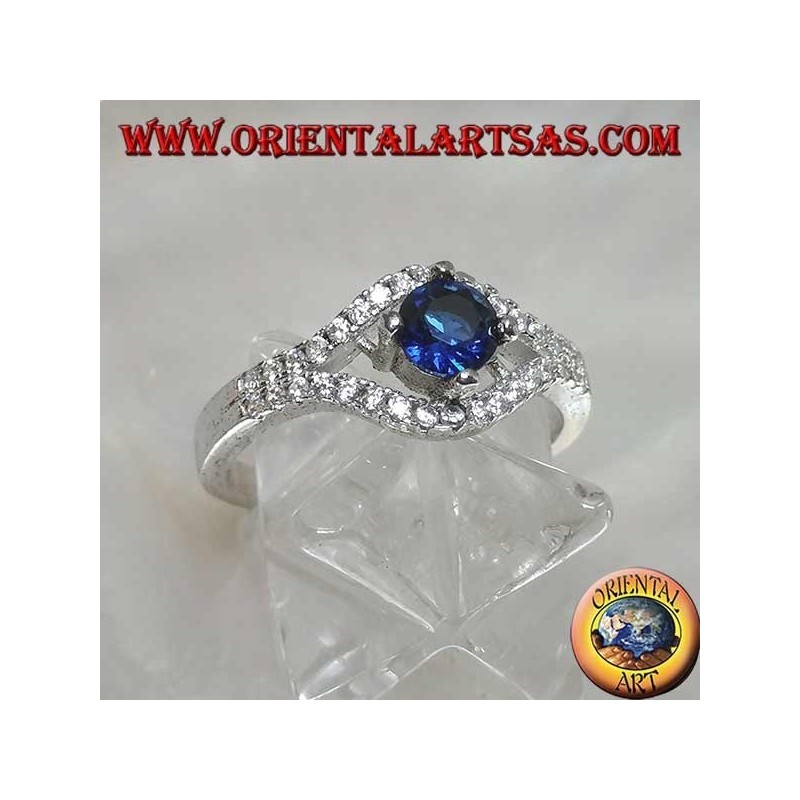 Silver ring in the shape of an eye with a set round synthetic sapphire and contour zircons