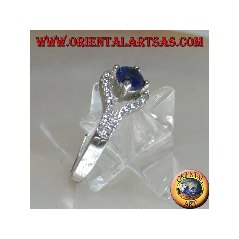 Silver ring in the shape of an eye with a set round synthetic sapphire and contour zircons