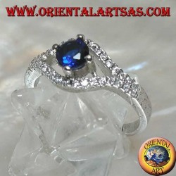 Silver ring in the shape of an eye with a set round synthetic sapphire and contour zircons