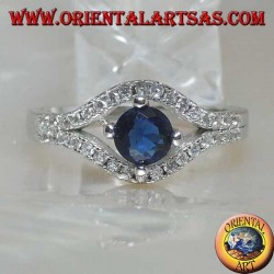 Silver ring in the shape of an eye with a set round synthetic sapphire and contour zircons