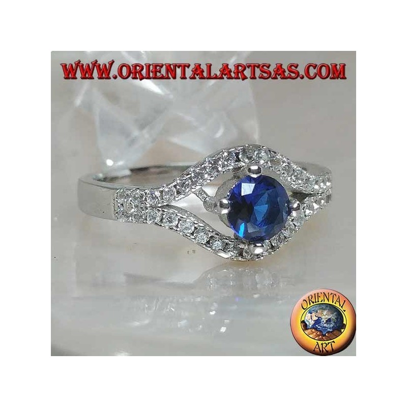 Silver ring in the shape of an eye with a set round synthetic sapphire and contour zircons