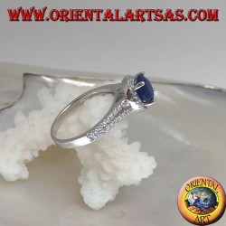 Silver ring with round synthetic sapphire set surrounded by raised zircons