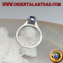 Silver ring with round synthetic sapphire set surrounded by raised zircons