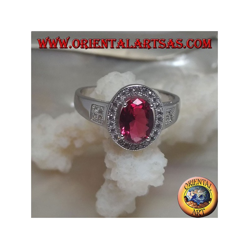 Silver ring with oval synthetic ruby set surrounded by cubic zirconia and square on the sides