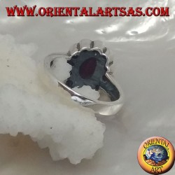 Silver ring with oval natural ruby set surrounded by small round rubies