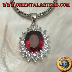 Silver pendant with faceted oval garnet set surrounded by round zircons