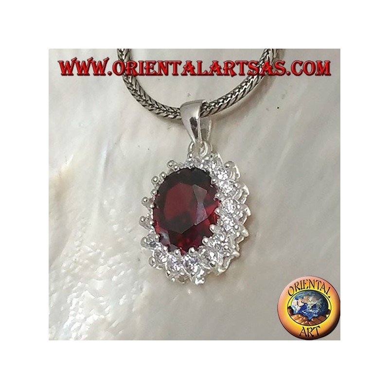Silver pendant with faceted oval garnet set surrounded by round zircons