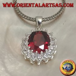 Silver pendant with faceted oval garnet set surrounded by round zircons