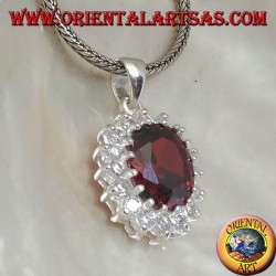 Silver pendant with faceted oval garnet set surrounded by round zircons