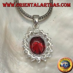 Silver pendant with faceted oval garnet set surrounded by round zircons