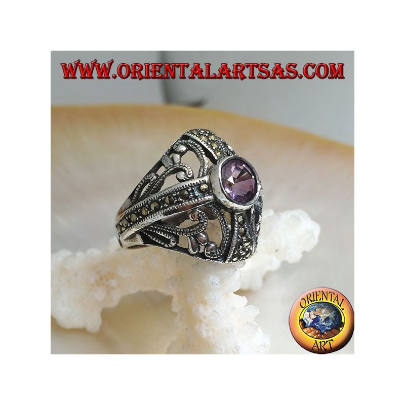 Rounded silver ring with round natural amethyst on a marcasite cross and openwork decorations