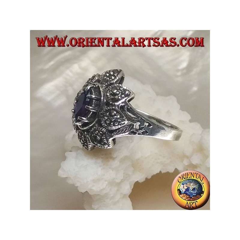 Silver flower ring with central shuttle amethyst-colored zircon and marcasite petals
