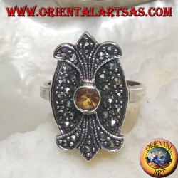 Silver ring with round yellow topaz on oval shield with double mirror lily studded with marcasite